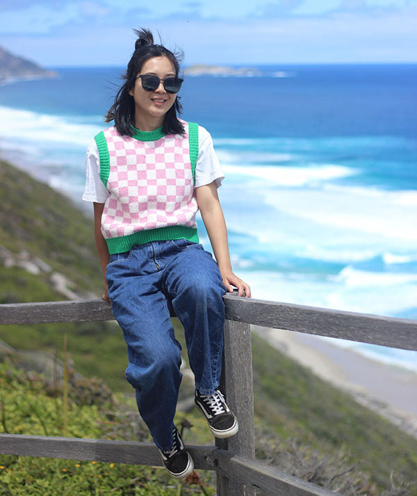 Bursary recipient student Hong Ye by the beach