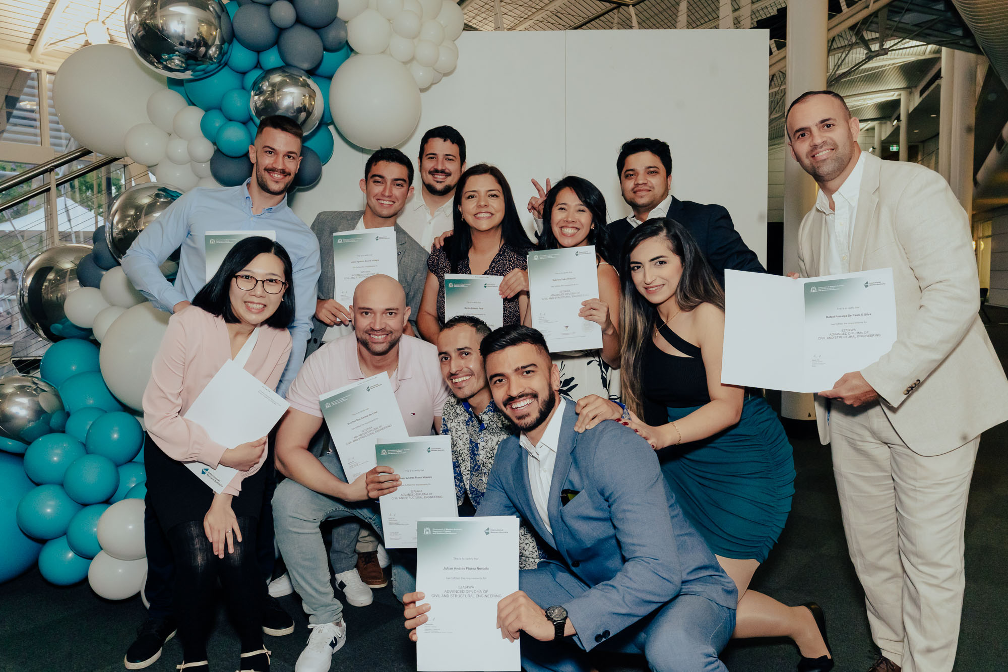 Group of TAFE international students pose with their graduation certificates