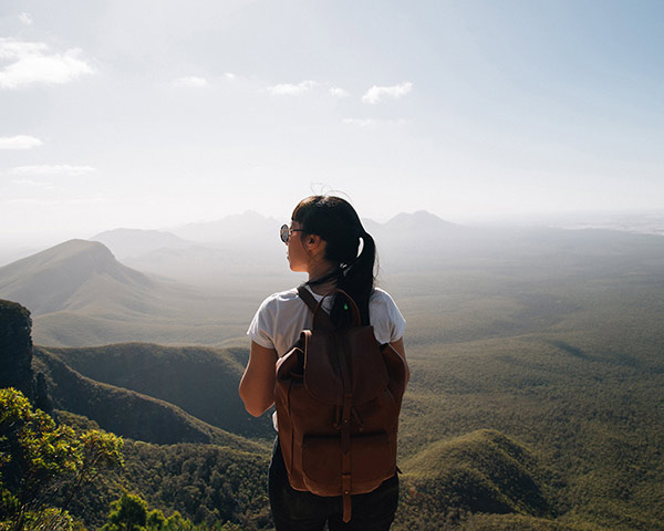 Person overlooking rolling green hills