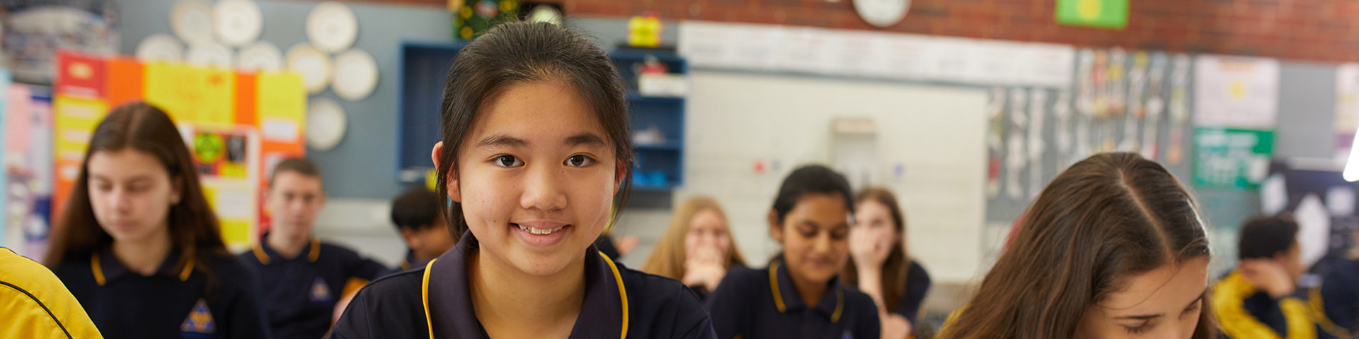 Student smiling in school classroom