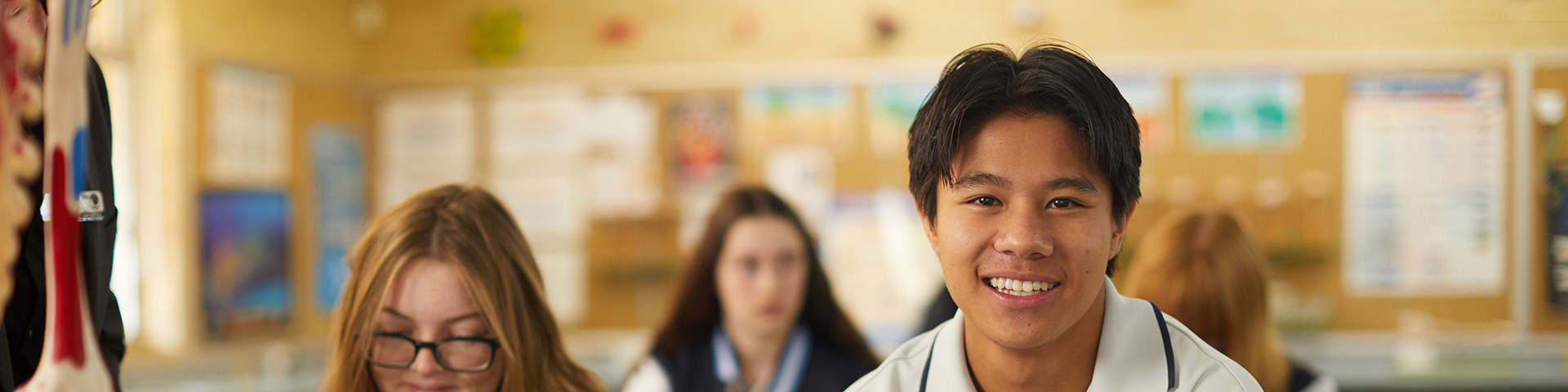 School student smiling in classroom