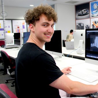 Design student at computer, doing design work