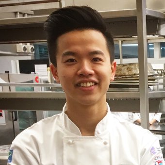 International student Josh smiling, in kitchen training facilities
