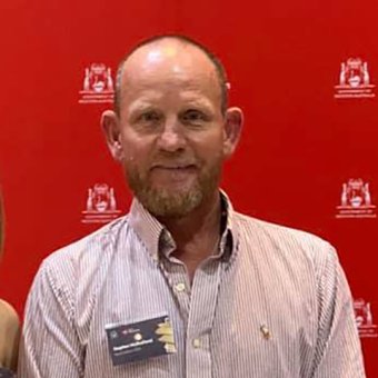 Lecturer Steve Mulholland, posing with student