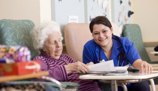 Person reading papers with an elderly person