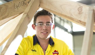 Person under a framework structure in construction attire