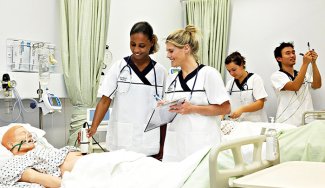 People observing nursing simulation mannequin/s