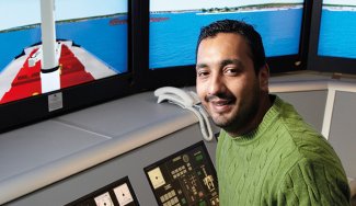 Person in front of a Vessel Traffic Service Simulator