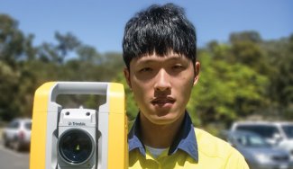 Person in front of surveying equipment