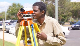 Person using surveying equipment