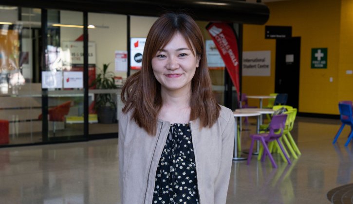 Student Sachiho smiles towards the camera. She stands in the foyer of North Metropolitan TAFE's Perth campus.