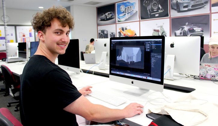 Design student at computer, doing design work