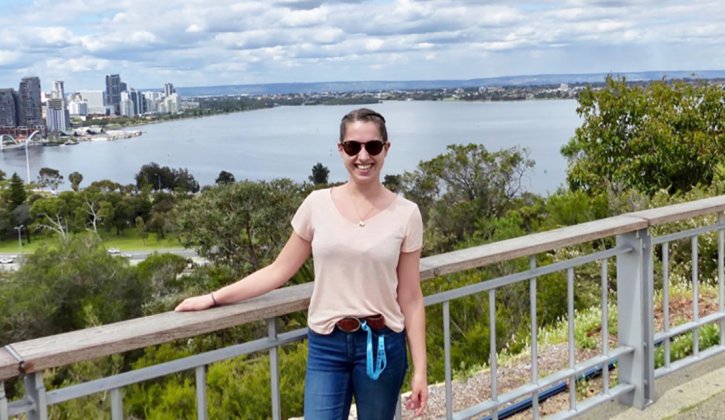 Johanna stands with Perth city skyline and river in background