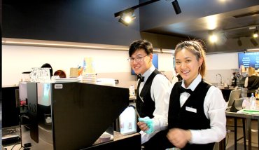 Two students working at a cafe