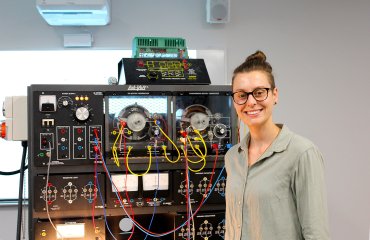 student in front of electrical equipment