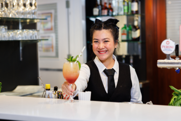 Hospitality student serving cocktail