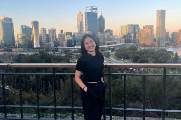 Shannen from the Philippines stands in front of Perth city skyline